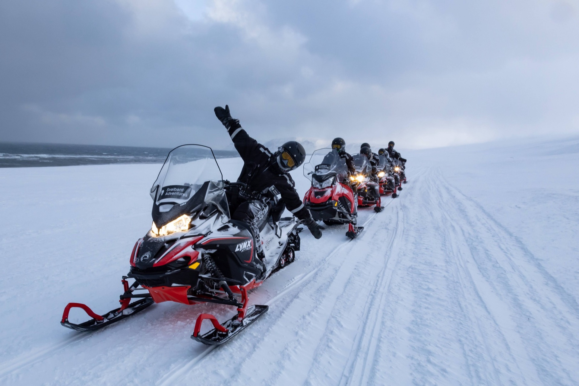 Snowmobile group ready to depart on a guided Svalbard expedition